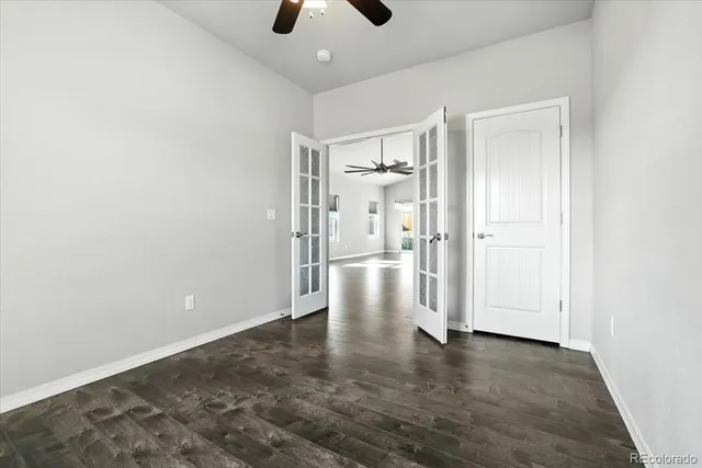 a view of empty room with wooden floor