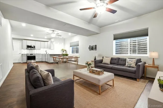 a living room with furniture and kitchen view
