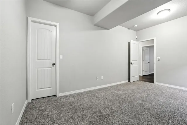 an empty room with closet and a bathroom