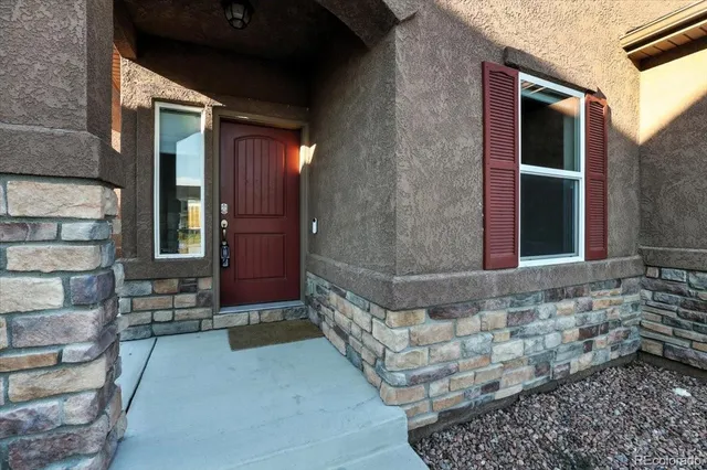a view of front door of house with stairs