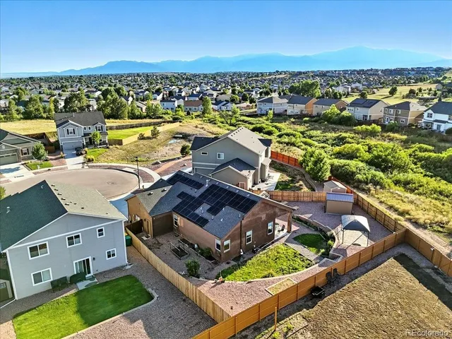 an aerial view of a house with a ocean view