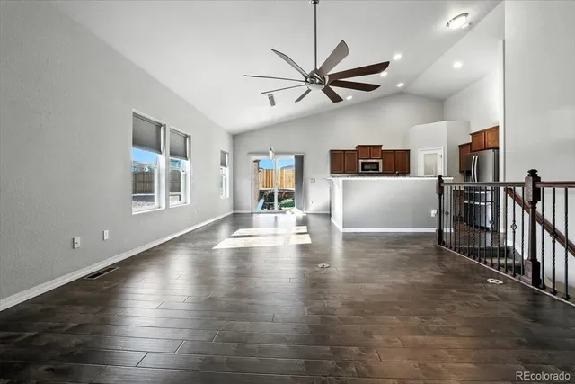 a view of empty room with wooden floor and window