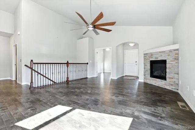 a view of empty room with wooden floor and fireplace