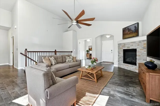 a living room with furniture kitchen view and a fireplace