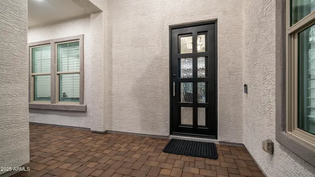a living room with furniture a rug and a large window