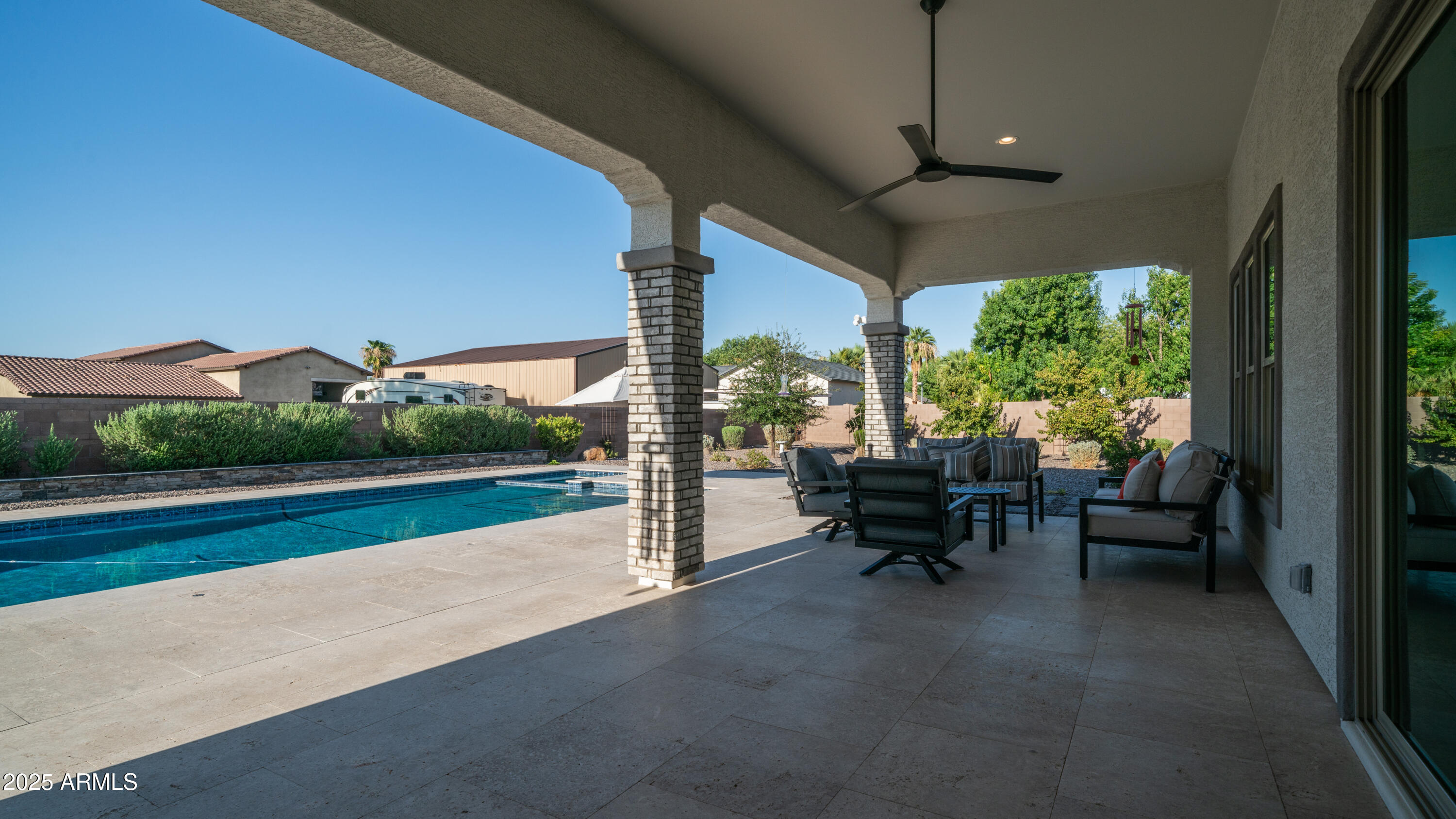2086 East Trigger Way Gilbert, AZ 85297 - Photo 30 of 69 a living room with patio furniture and a floor to ceiling window