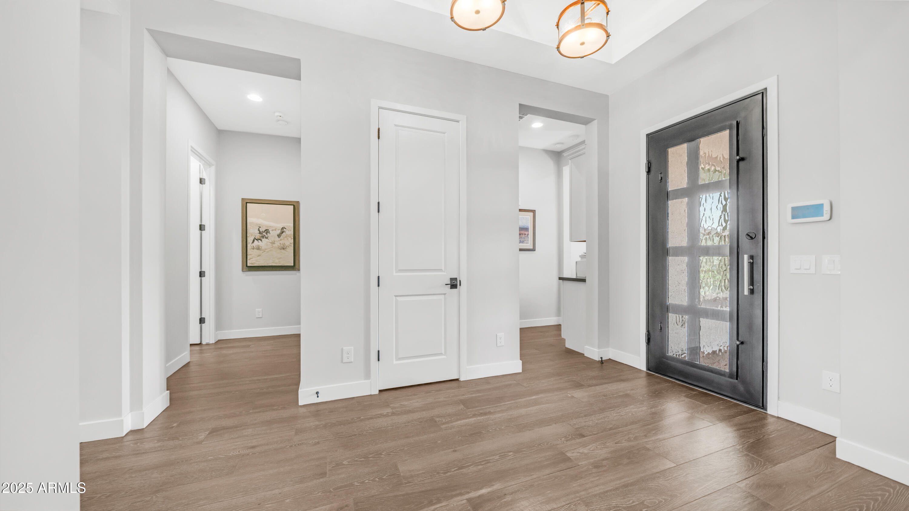 2086 East Trigger Way Gilbert, AZ 85297 - Photo 32 of 69 a view of an empty room with wooden floor and a bathroom