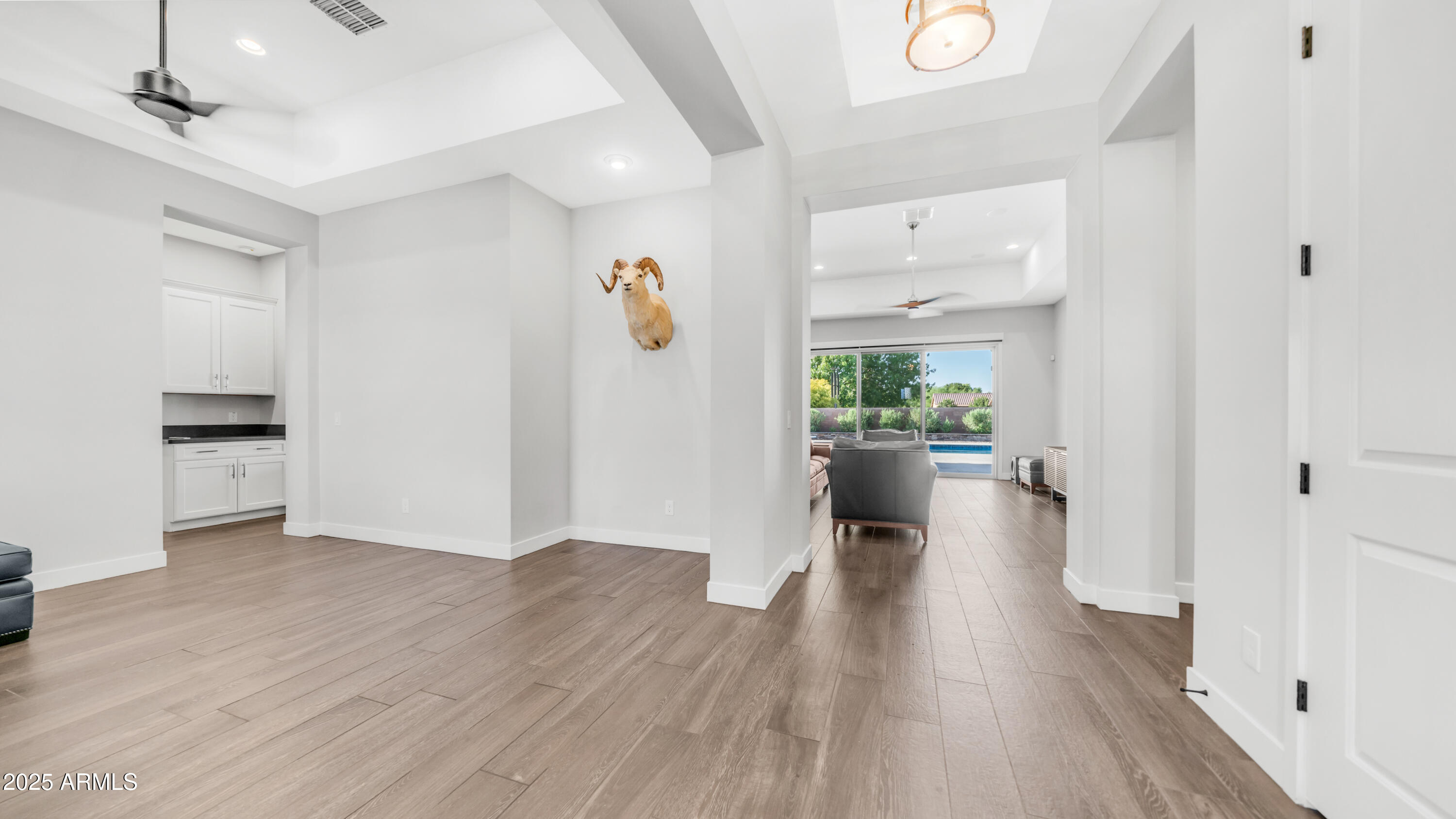 2086 East Trigger Way Gilbert, AZ 85297 - Photo 36 of 69 a view of a hallway view with wooden floor and a kitchen space