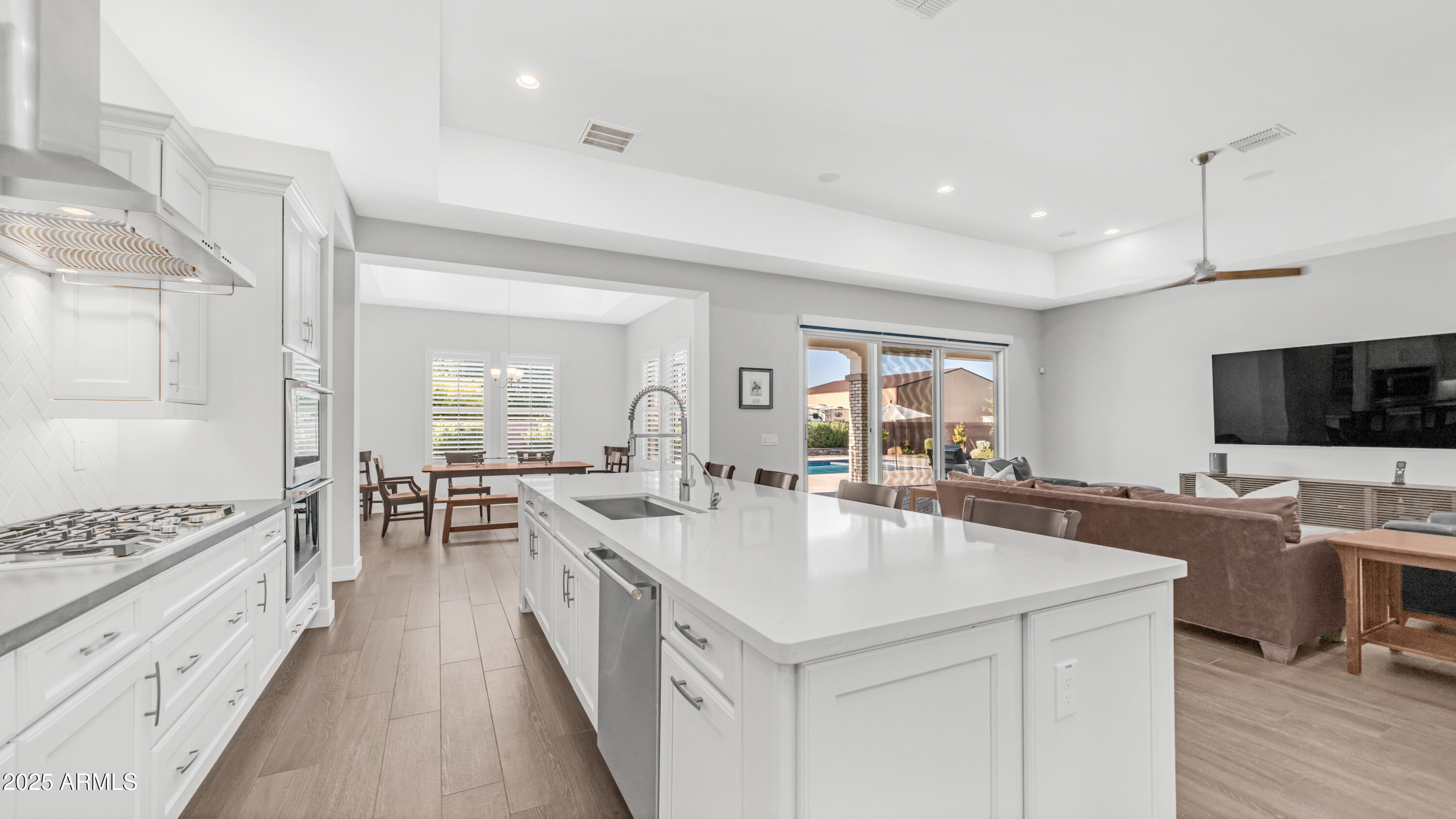 2086 East Trigger Way Gilbert, AZ 85297 - Photo 5 of 69 a large kitchen with kitchen island a sink counter space and stainless steel appliances