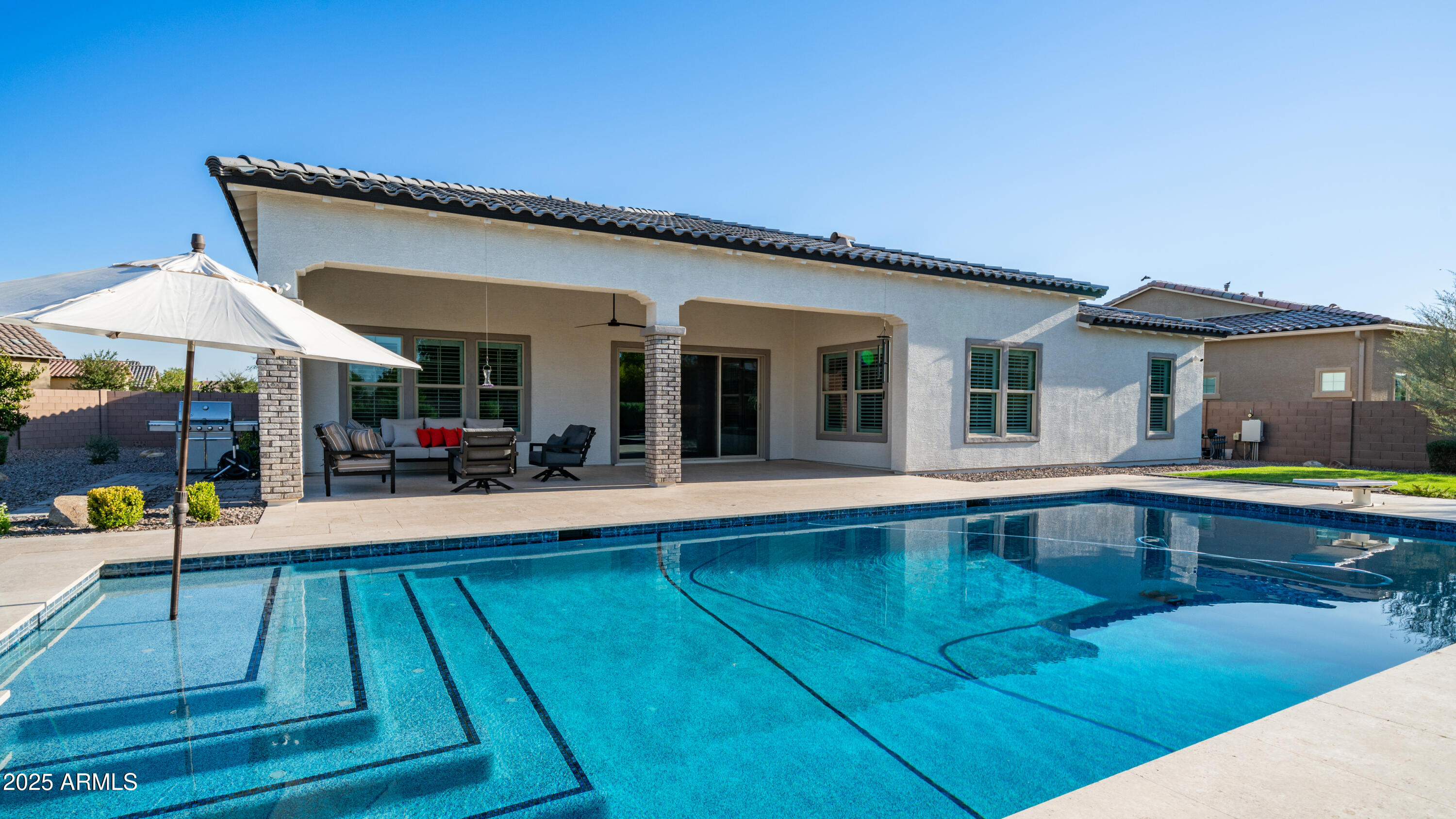 2086 East Trigger Way Gilbert, AZ 85297 - Photo 64 of 69 a swimming pool with patio outdoor seating and yard