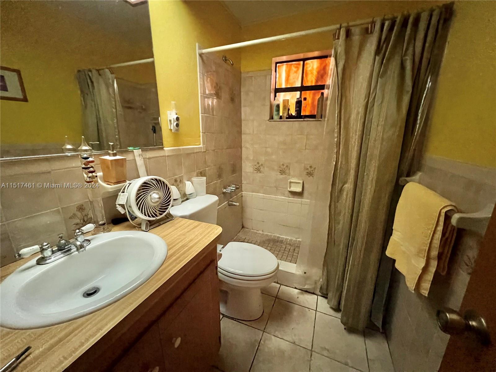 2675 Southwest 24th Terrace Miami, FL 33145 - Photo 13 of 17 a bathroom with a sink and mirror with toilet