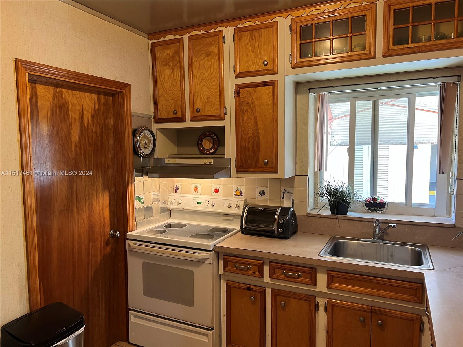 2675 Southwest 24th Terrace Miami, FL 33145 - Photo 6 of 17 a kitchen with a refrigerator and a sink