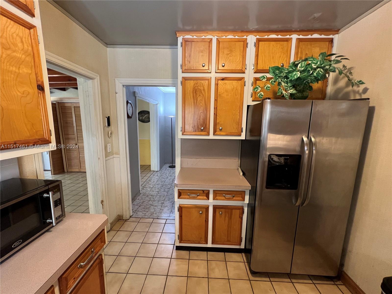 2675 Southwest 24th Terrace Miami, FL 33145 - Photo 7 of 17 a kitchen with granite countertop a refrigerator a stove and a sink