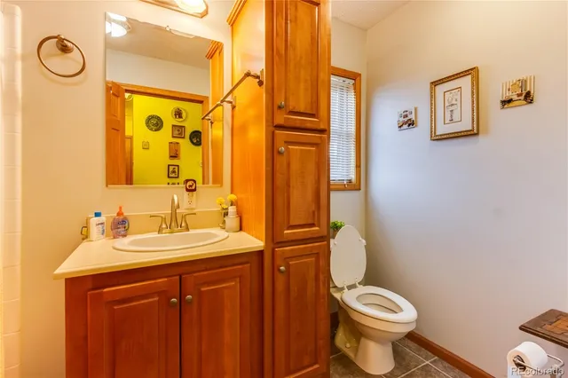 a bathroom with a sink vanity mirror and toilet