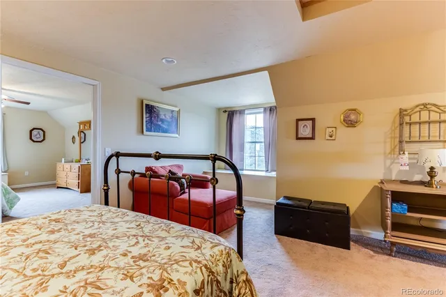 a bedroom with a bed and a dresser in it