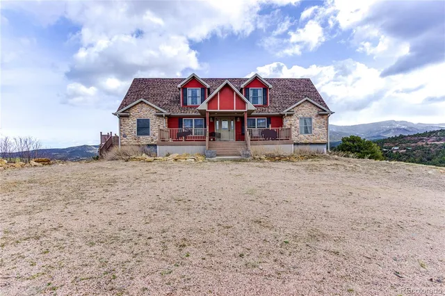 a view of a big house with a big yard and large trees