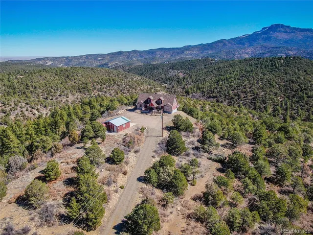 a view of a lush green hillside and a houses