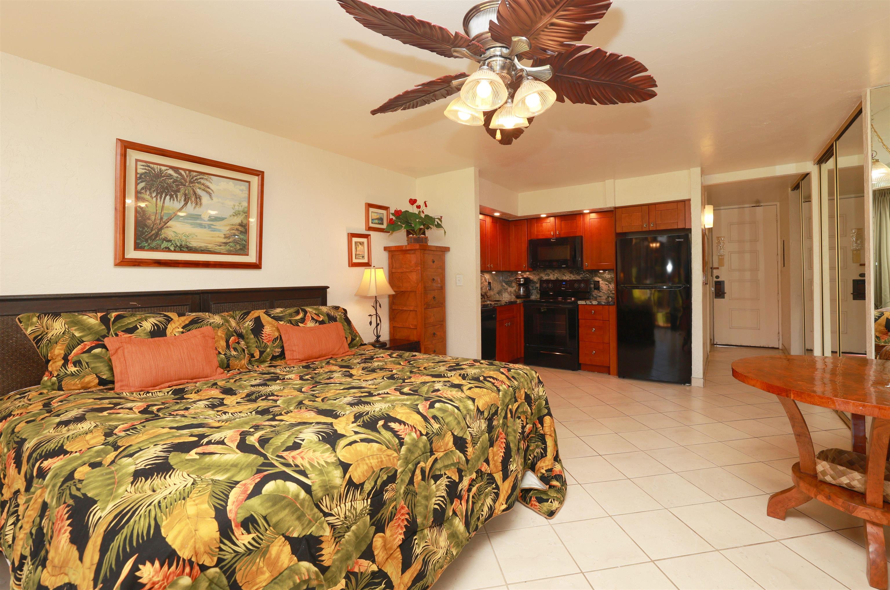 3543 Lower Honoapiilani Road, Unit C107 Lahaina, HI 96761 - Photo 19 of 49 a large bedroom with a bed and a chandelier
