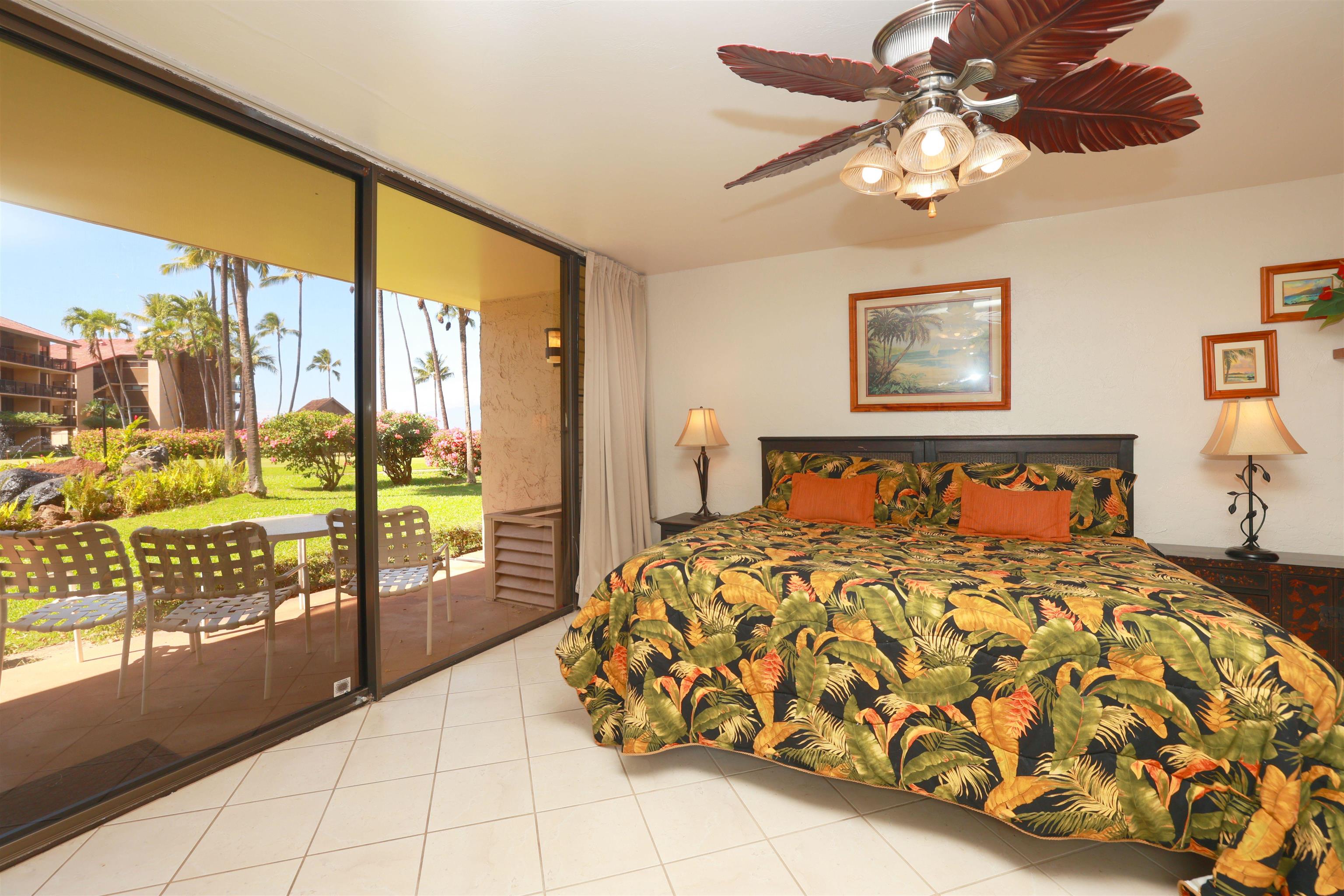3543 Lower Honoapiilani Road, Unit C107 Lahaina, HI 96761 - Photo 2 of 49 a bedroom with a large bed and a tv