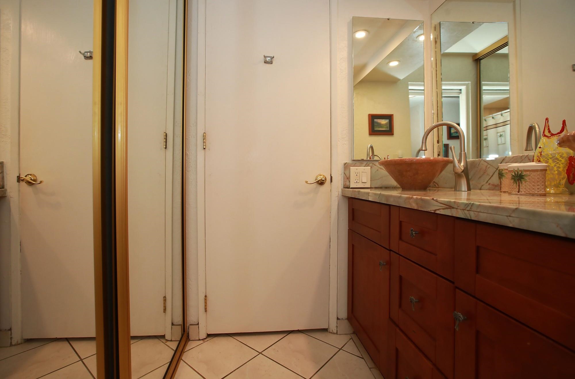 3543 Lower Honoapiilani Road, Unit C107 Lahaina, HI 96761 - Photo 28 of 49 a bathroom with a granite countertop sink and a mirror