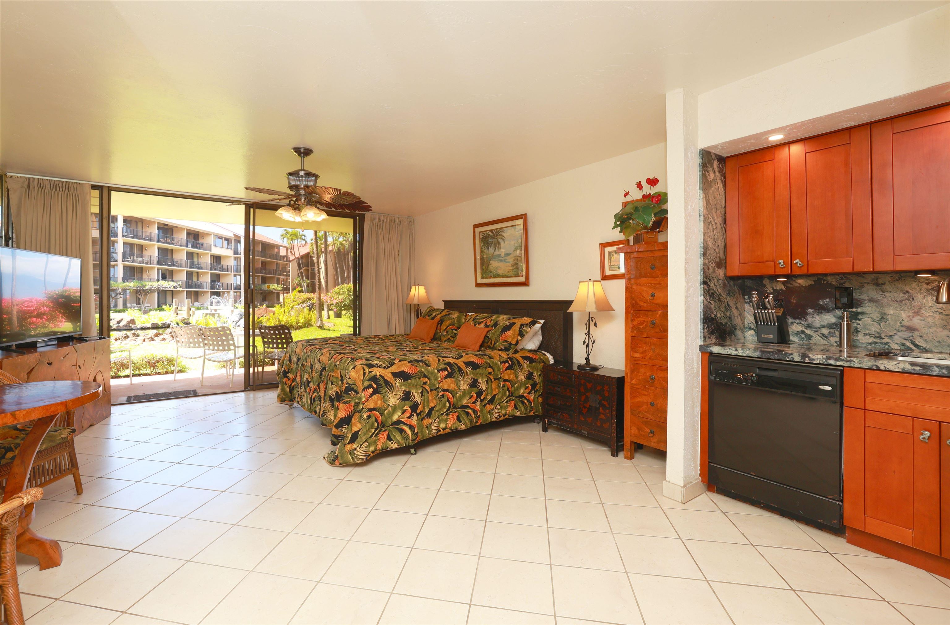 3543 Lower Honoapiilani Road, Unit C107 Lahaina, HI 96761 - Photo 3 of 49 a bed room with a bed and a television
