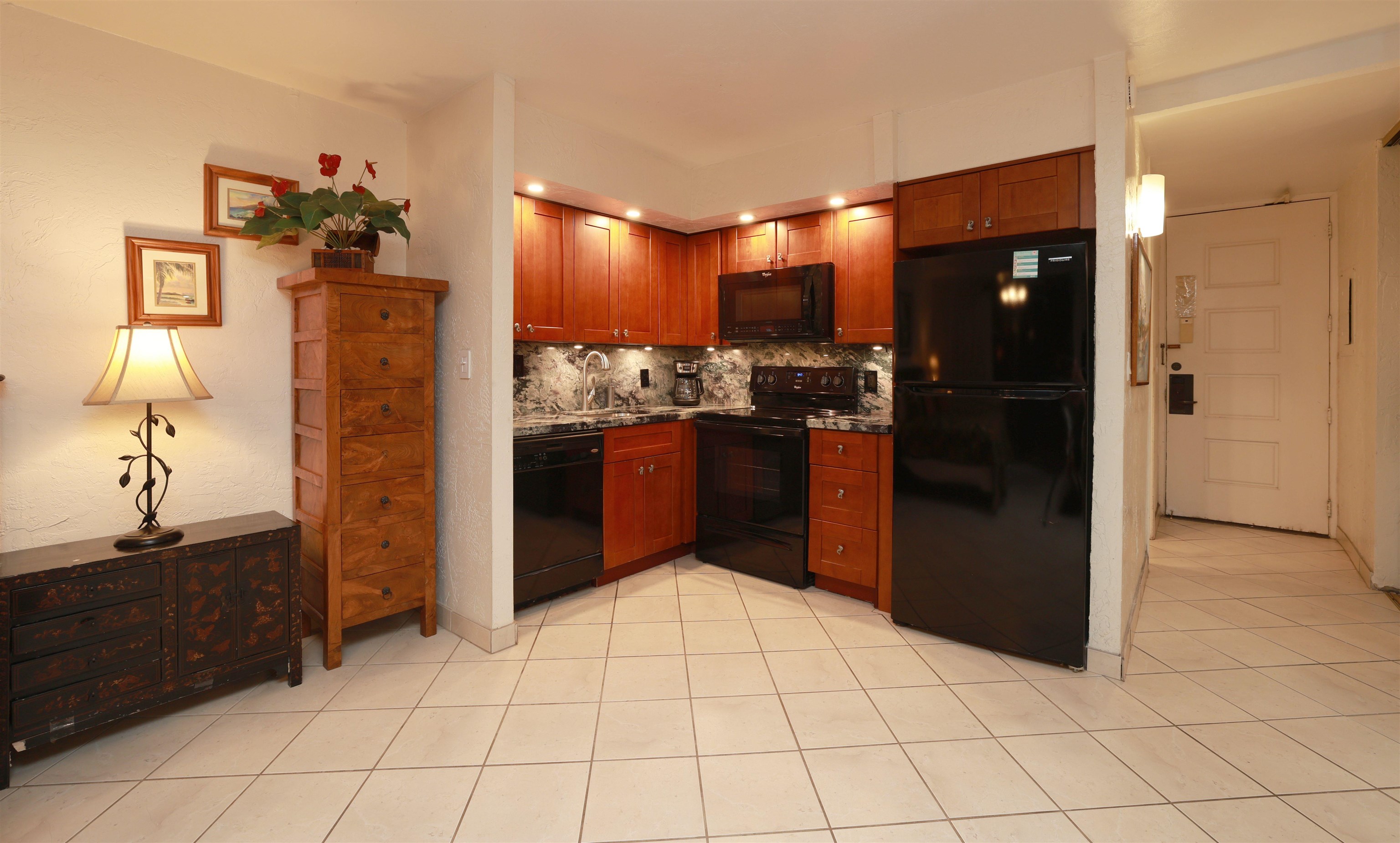 3543 Lower Honoapiilani Road, Unit C107 Lahaina, HI 96761 - Photo 4 of 49 a kitchen with stainless steel appliances granite countertop a refrigerator and a stove