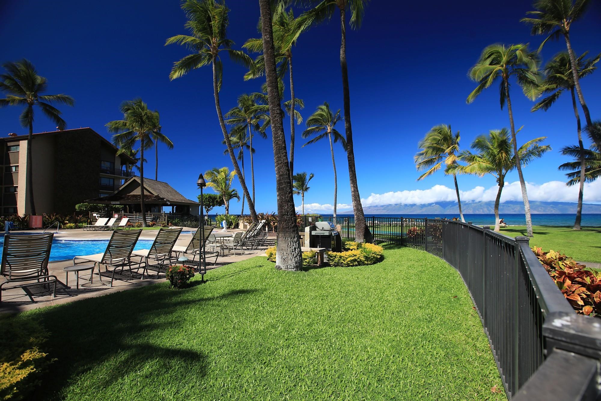 3543 Lower Honoapiilani Road, Unit C107 Lahaina, HI 96761 - Photo 43 of 49 a view of a swimming pool with a table and chairs