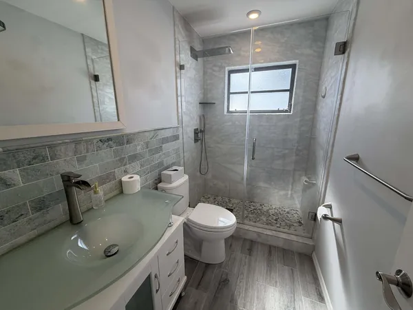 a bathroom with a toilet sink and shower
