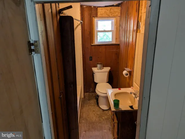 a bathroom with a toilet and a window