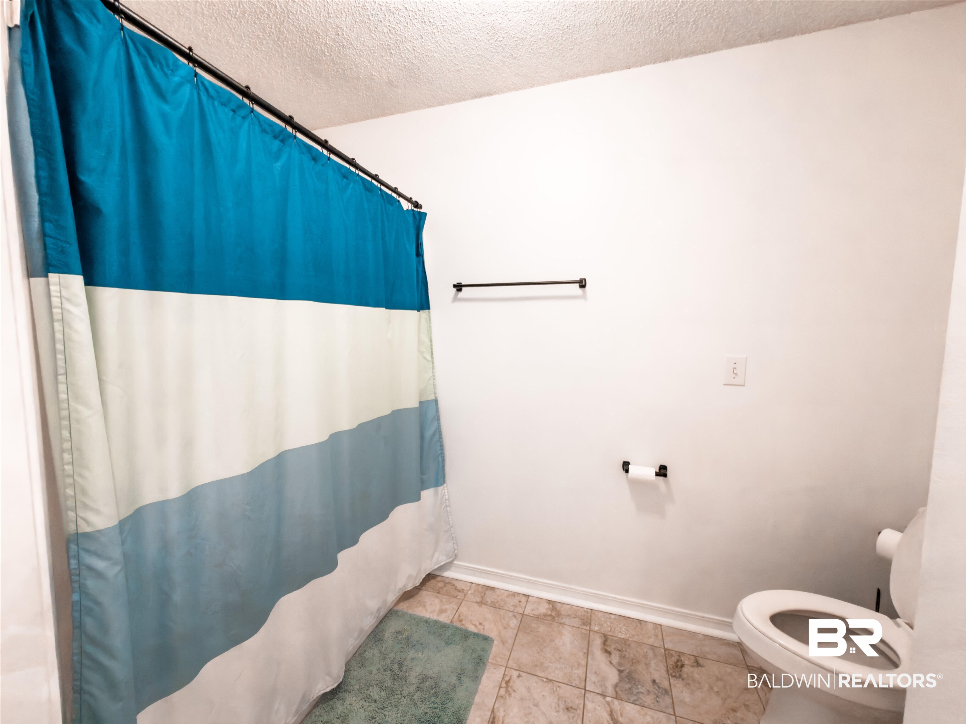 129 Pennbrooke Loop Foley, AL 36535 - Photo 30 of 44 Full bath with a textured ceiling and a shower with shower curtain