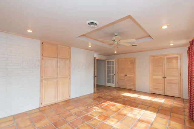 a view of a livingroom with wooden cabinets
