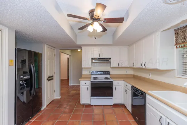 a kitchen with stainless steel appliances granite countertop a stove sink and refrigerator