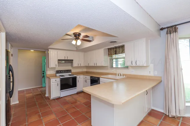 a kitchen with stainless steel appliances granite countertop a sink and a stove