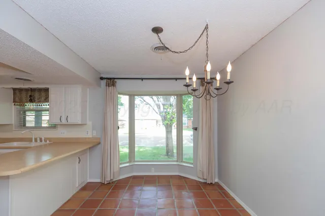 a view of a kitchen with a sink and dishwasher cabinets