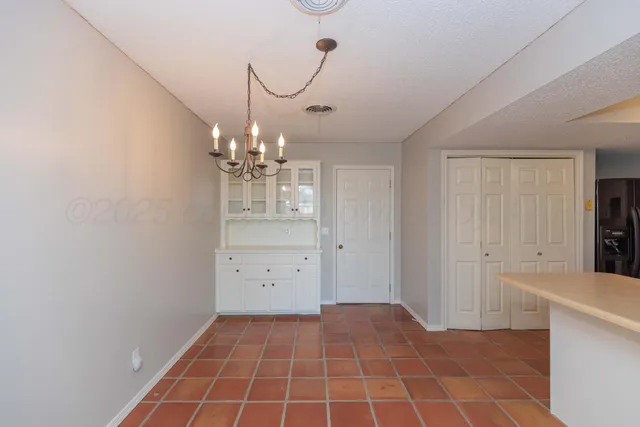 a view of a kitchen with a sink and cabinets