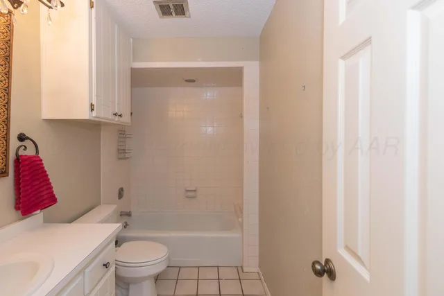 a bathroom with a toilet and shower