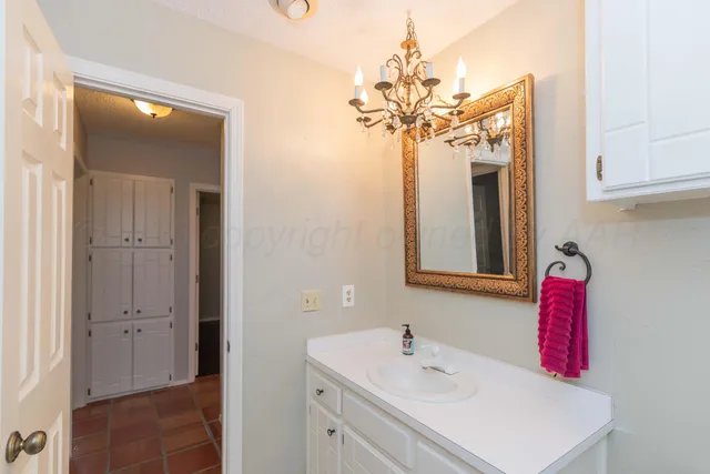 a bathroom with a sink a mirror and a shower