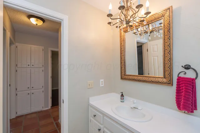 a bathroom with a sink vanity and mirror