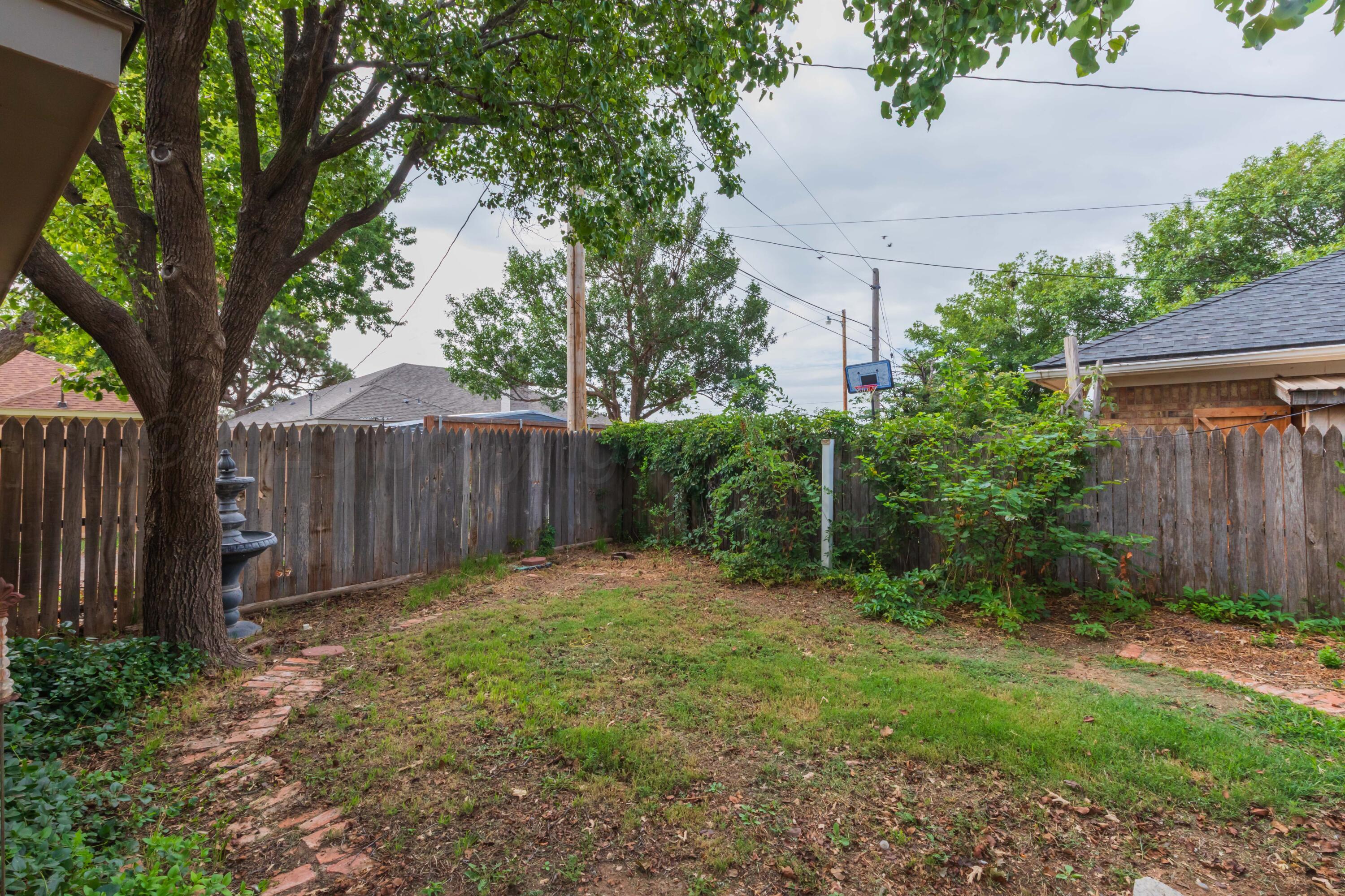 1031 Cimarron Trail Canyon, TX 79015 - Photo 48 of 50 a view of a backyard with large trees and wooden fence