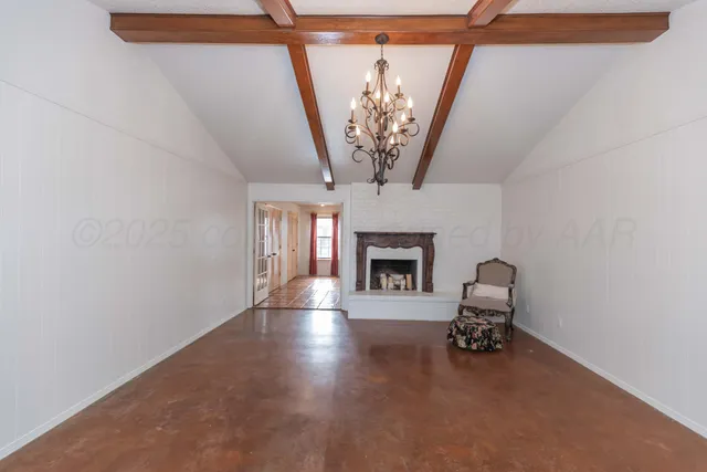 a view of empty room with furniture and fireplace