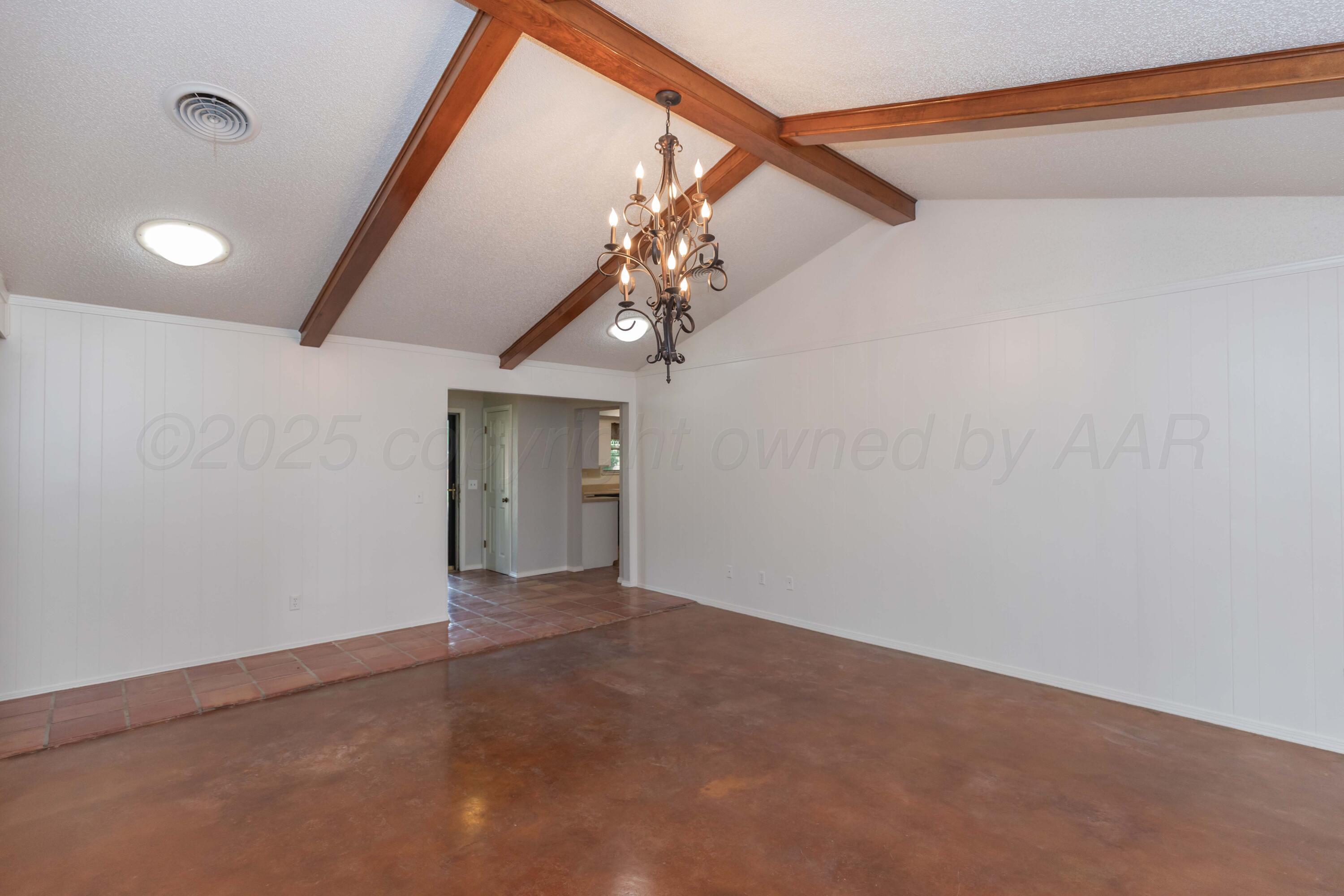 1031 Cimarron Trail Canyon, TX 79015 - Photo 9 of 50 a view of an empty room with a chandelier fan