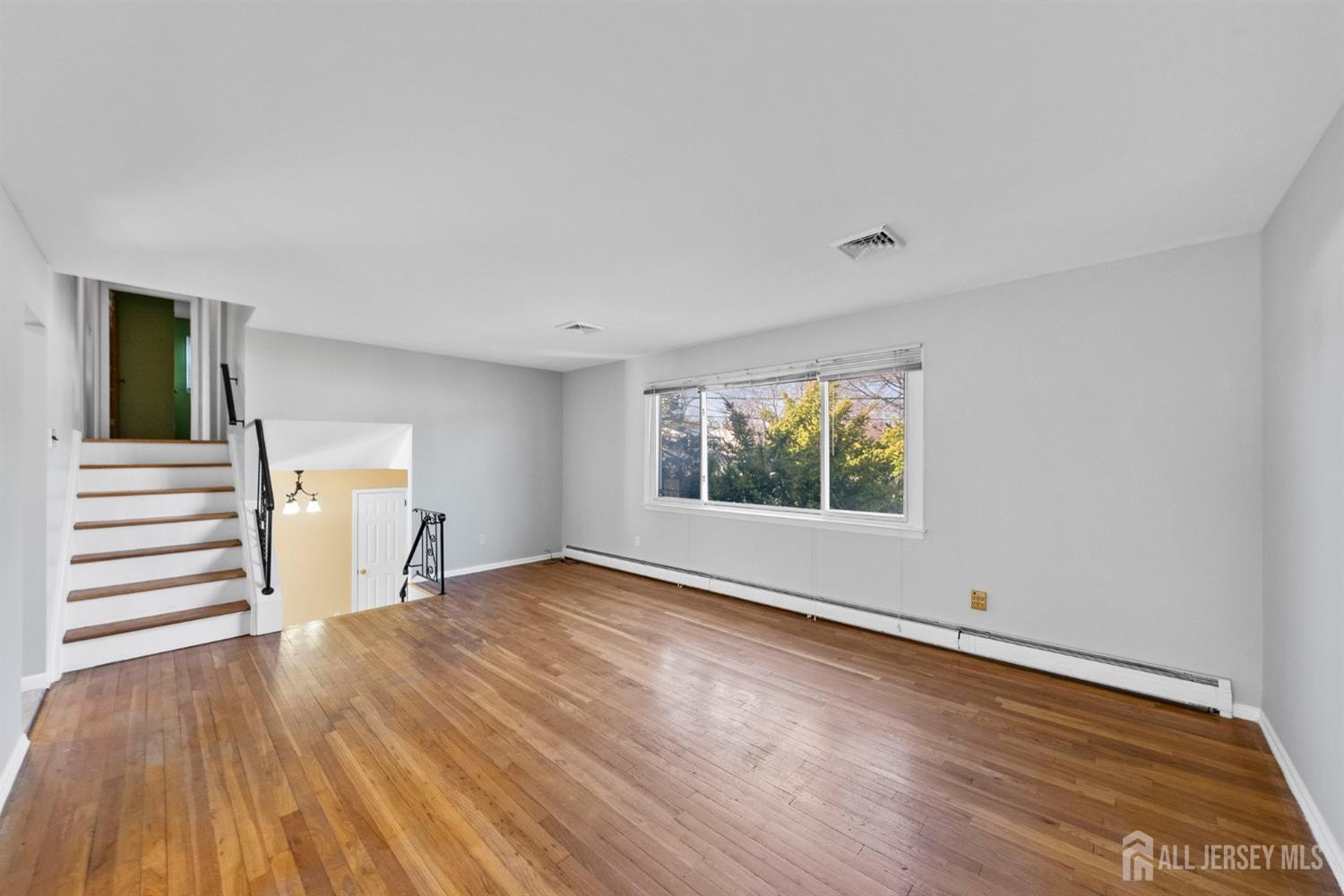 24 Lench Avenue Edison, NJ 08820 - Photo 12 of 38 wooden floor in an empty room with a window