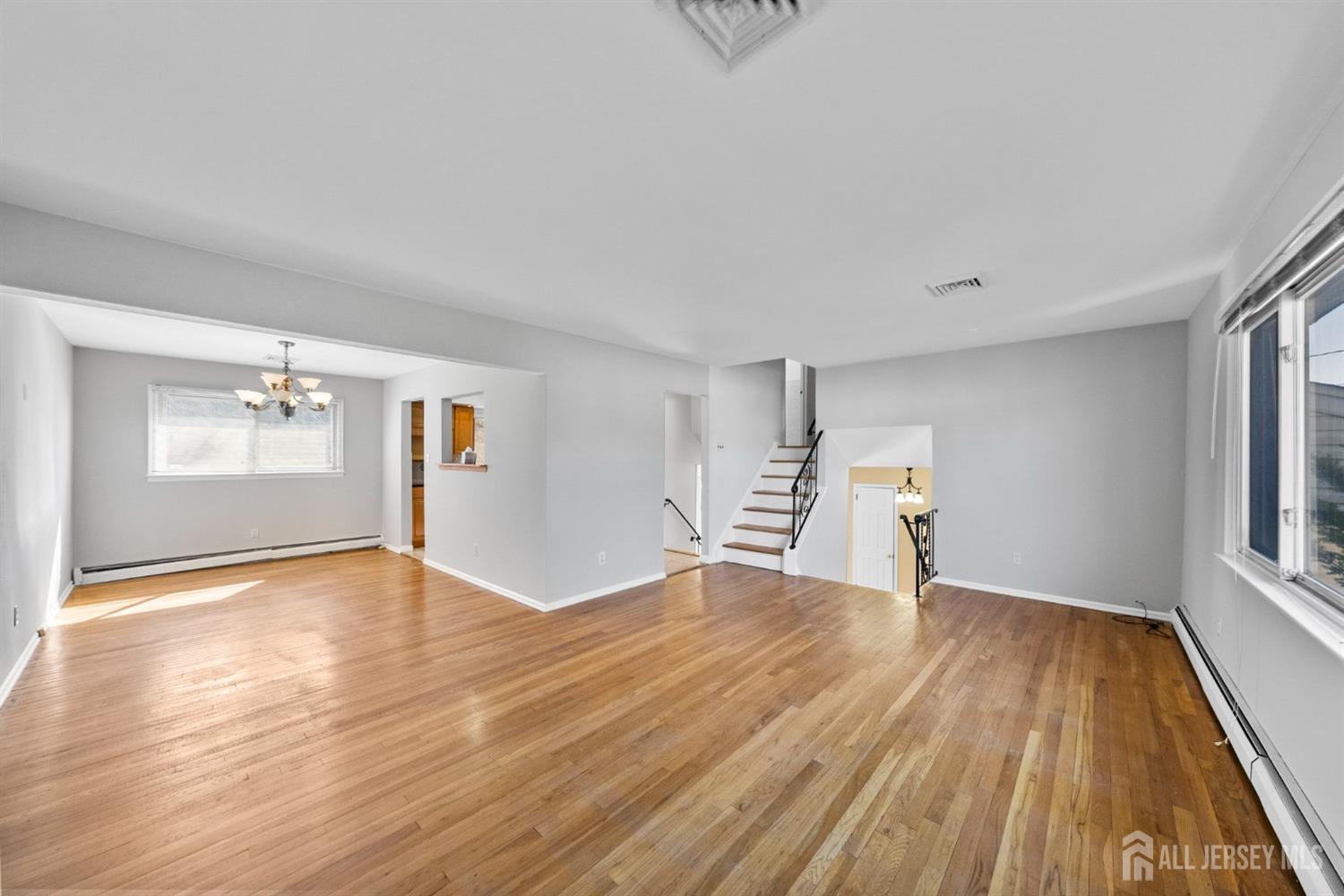 24 Lench Avenue Edison, NJ 08820 - Photo 13 of 38 a view of empty room with wooden floor and fan