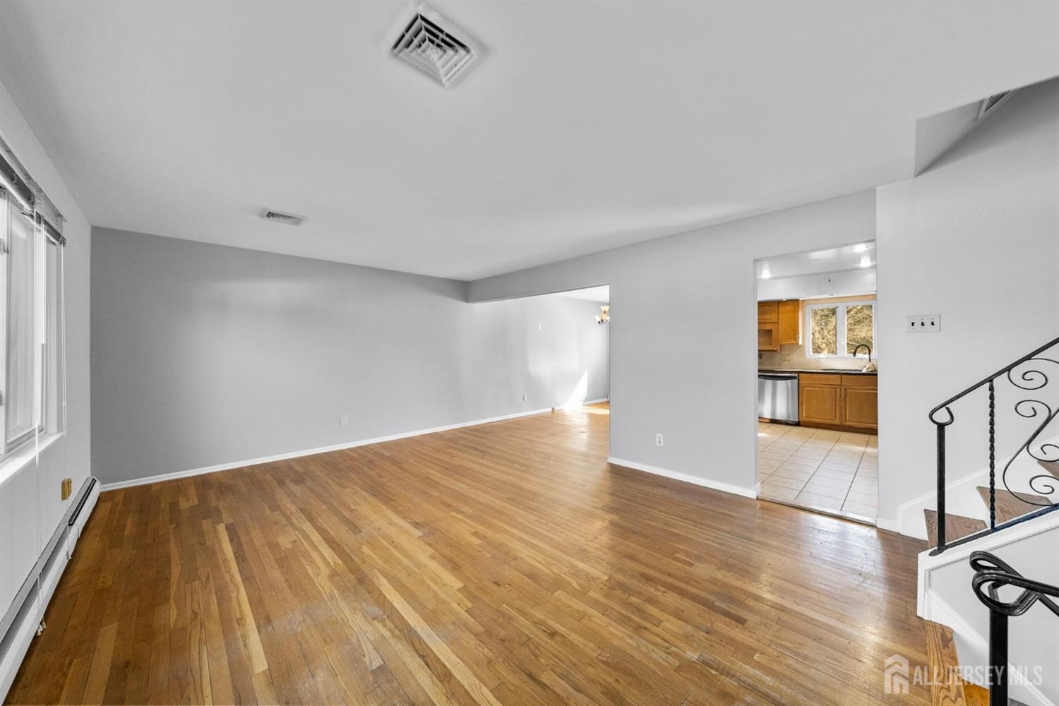 24 Lench Avenue Edison, NJ 08820 - Photo 17 of 38 a view of empty room with wooden floor and fan