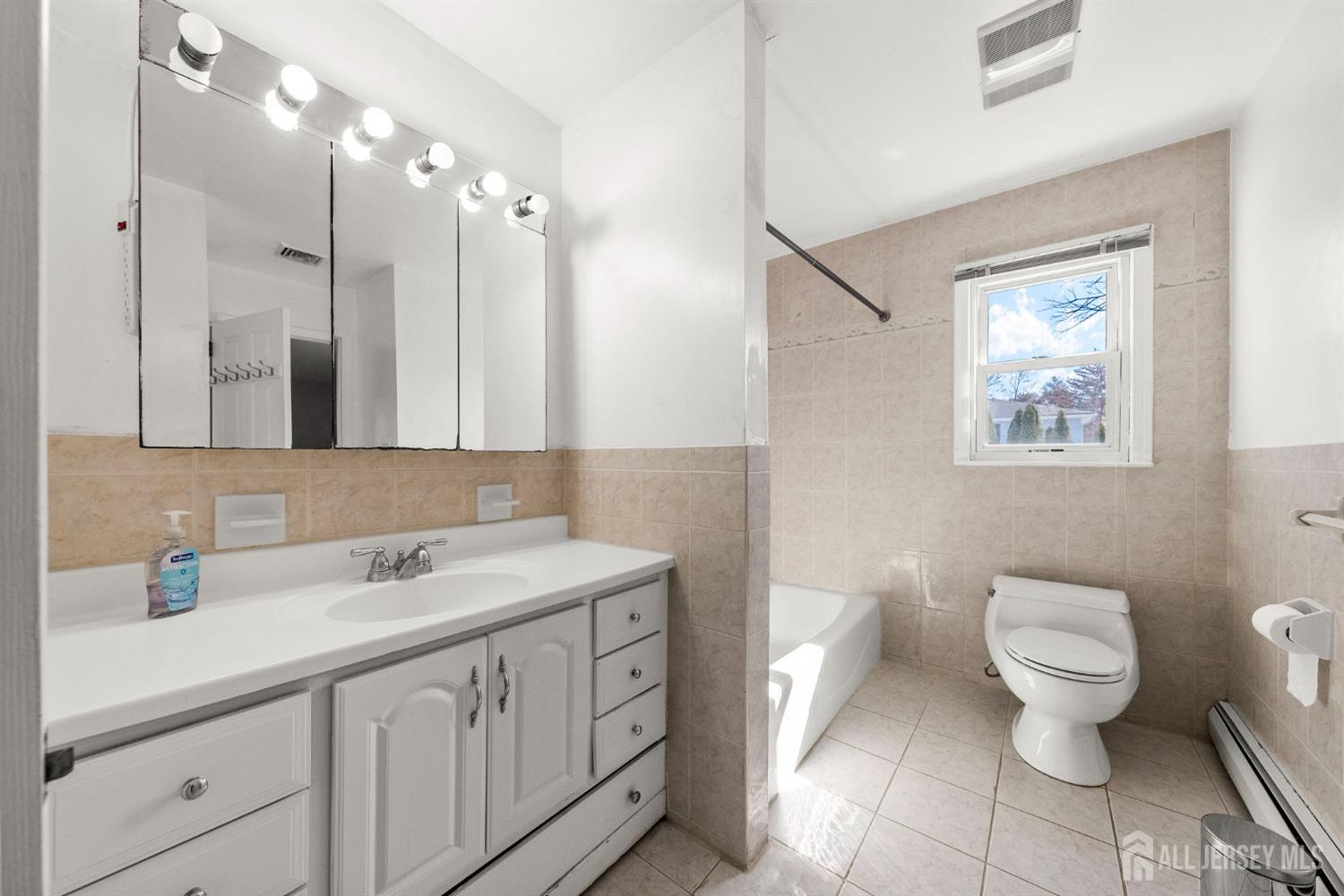 24 Lench Avenue Edison, NJ 08820 - Photo 25 of 38 a bathroom with a toilet sink and mirror