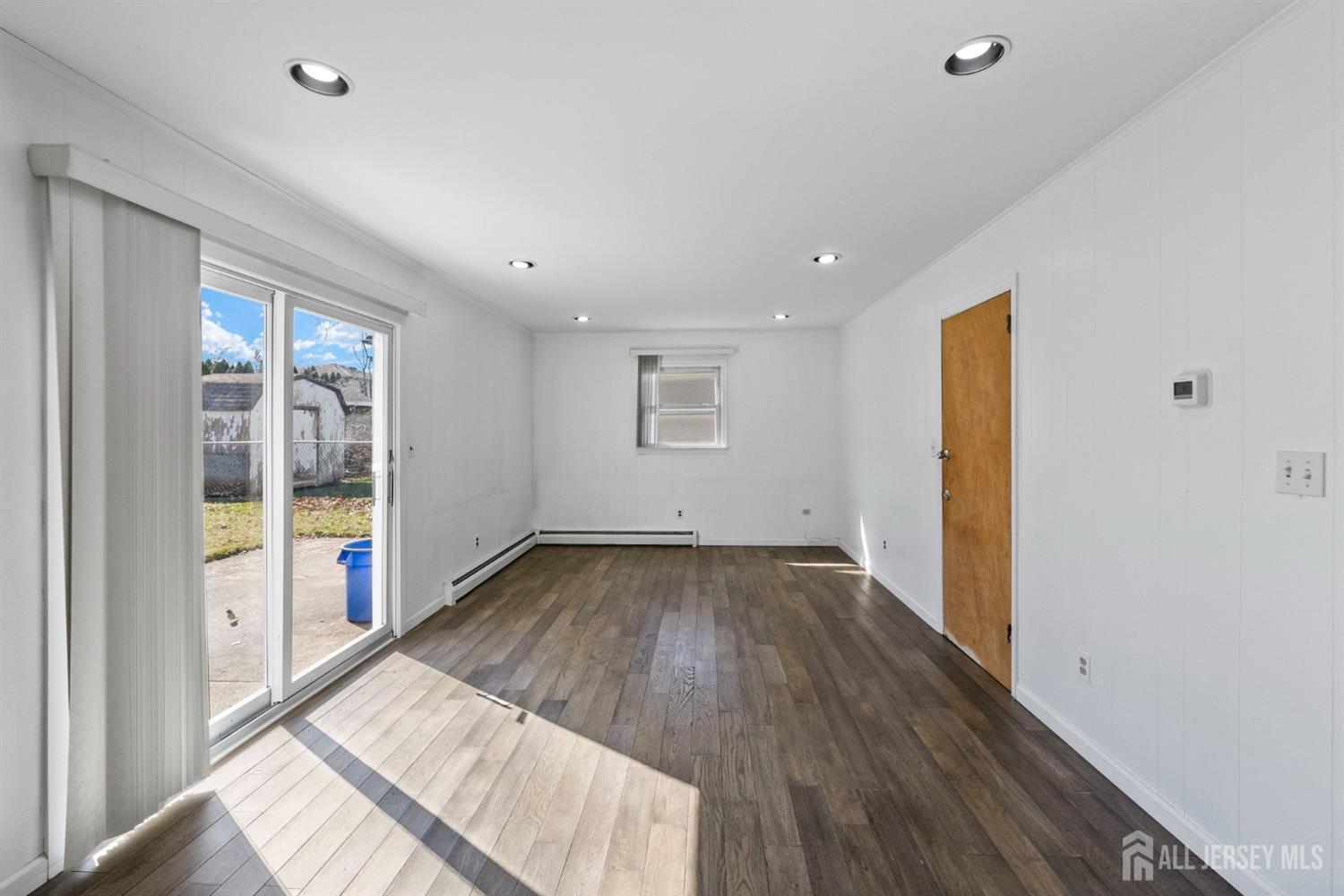 24 Lench Avenue Edison, NJ 08820 - Photo 10 of 38 a view of an empty room with wooden floor and a window