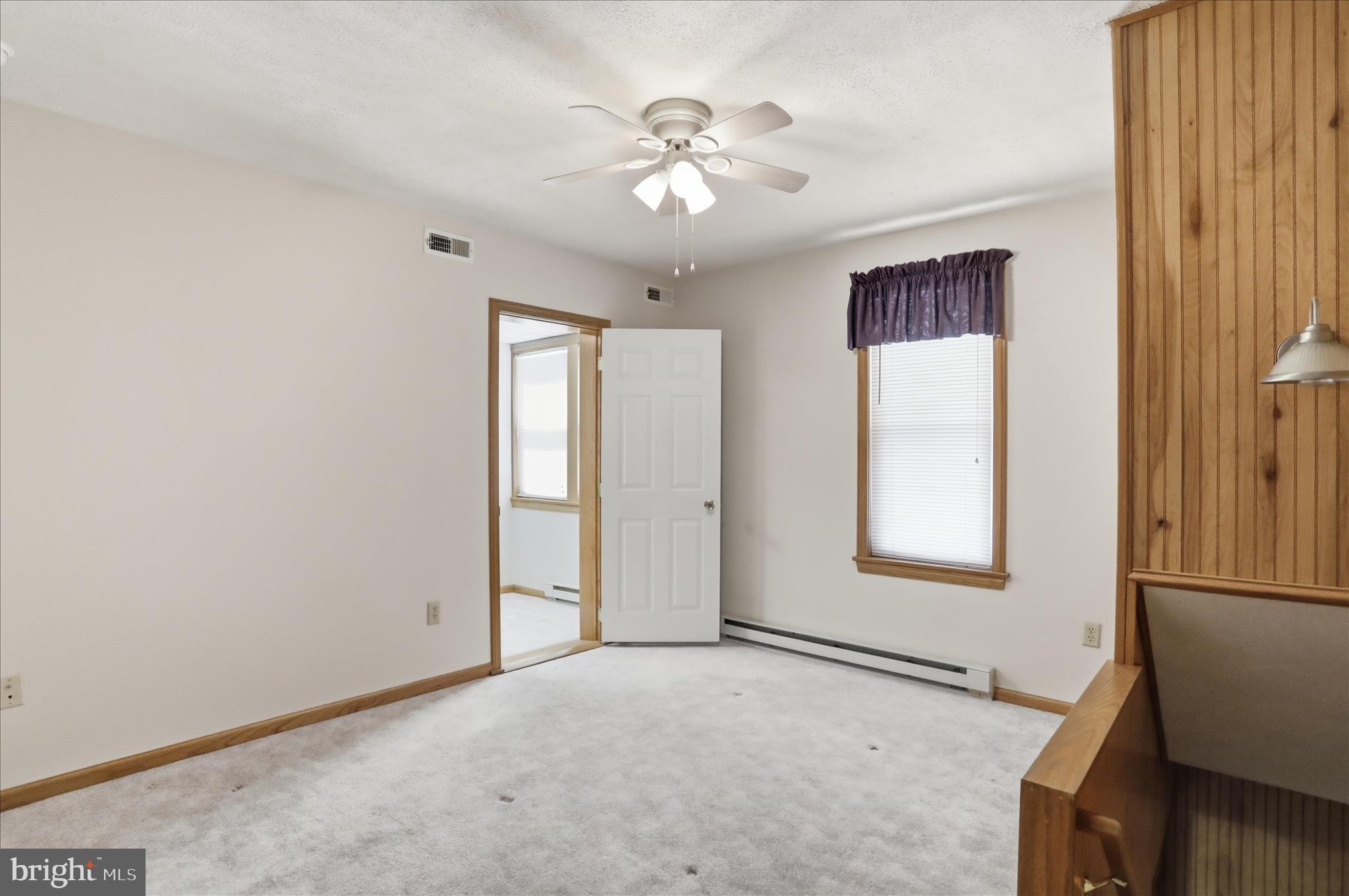 438 Chestnut Street Cumberland, MD 21502 - Photo 14 of 36 an empty room with windows and fan