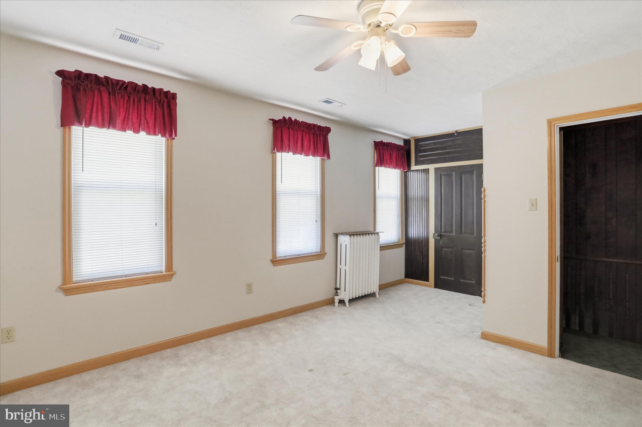 438 Chestnut Street Cumberland, MD 21502 - Photo 16 of 36 an empty room with windows and fan
