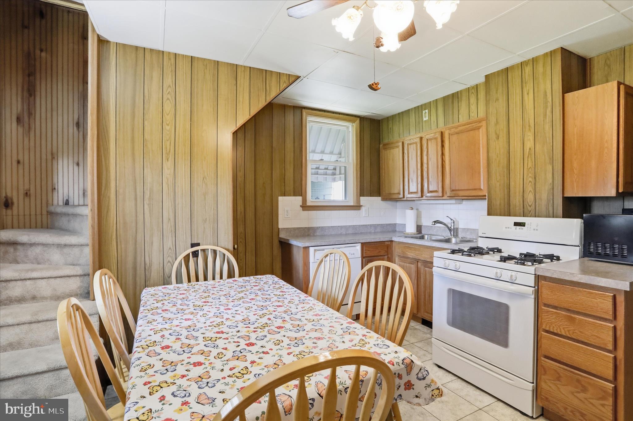 438 Chestnut Street Cumberland, MD 21502 - Photo 5 of 36 a kitchen with a stove a sink and a refrigerator