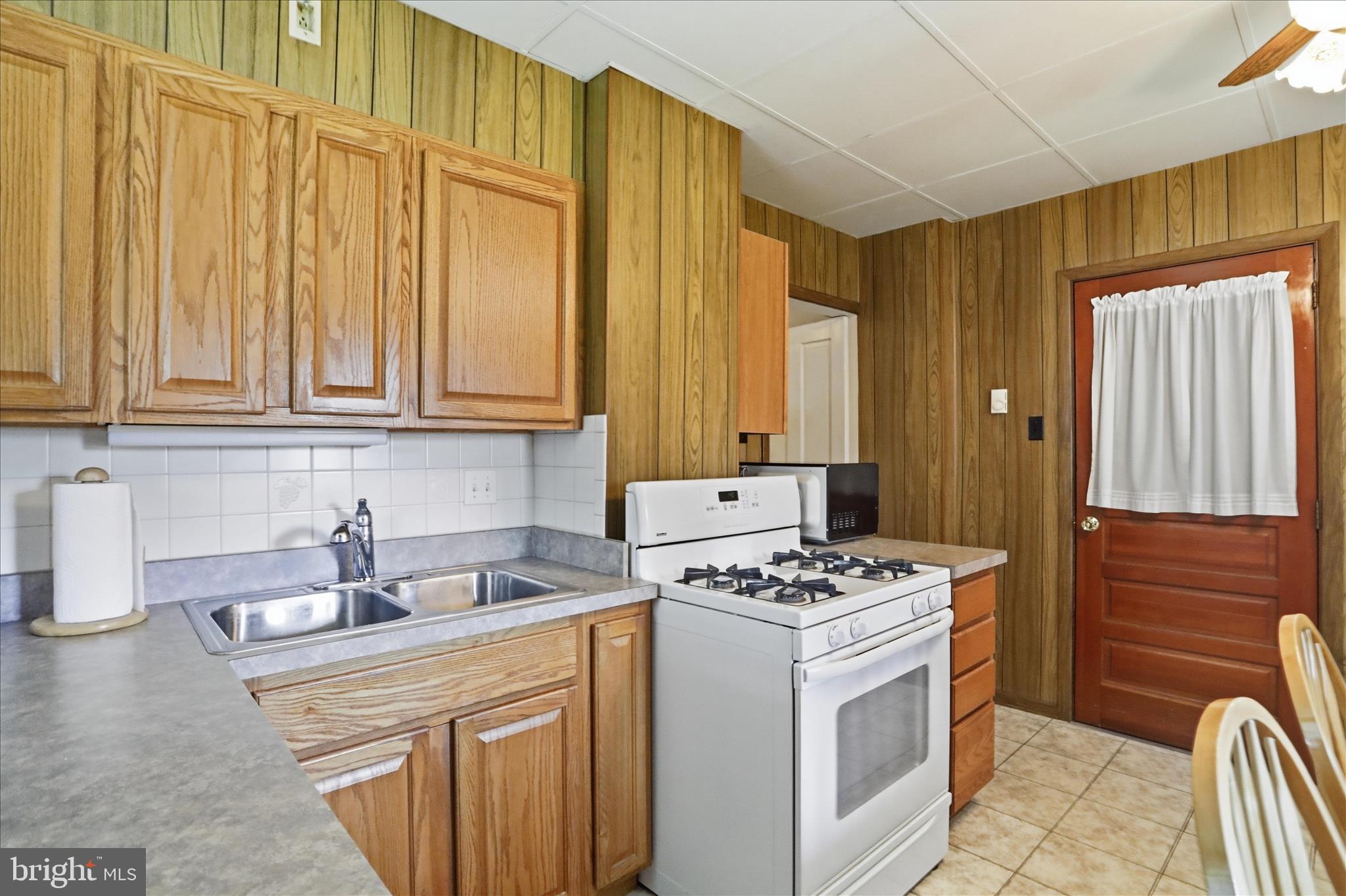 438 Chestnut Street Cumberland, MD 21502 - Photo 7 of 36 a kitchen with stainless steel appliances granite countertop a sink stove and cabinets